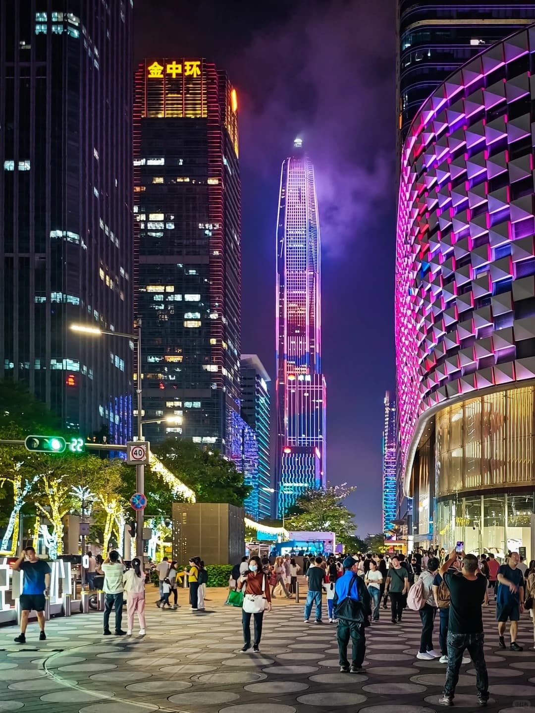 A well-lit street scene in Shenzhen at night showing the city's modern and safe urban environment