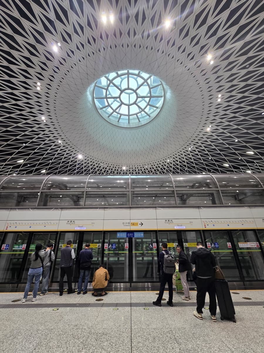 Inside a modern Shenzhen metro station showing clean platform and digital signage
