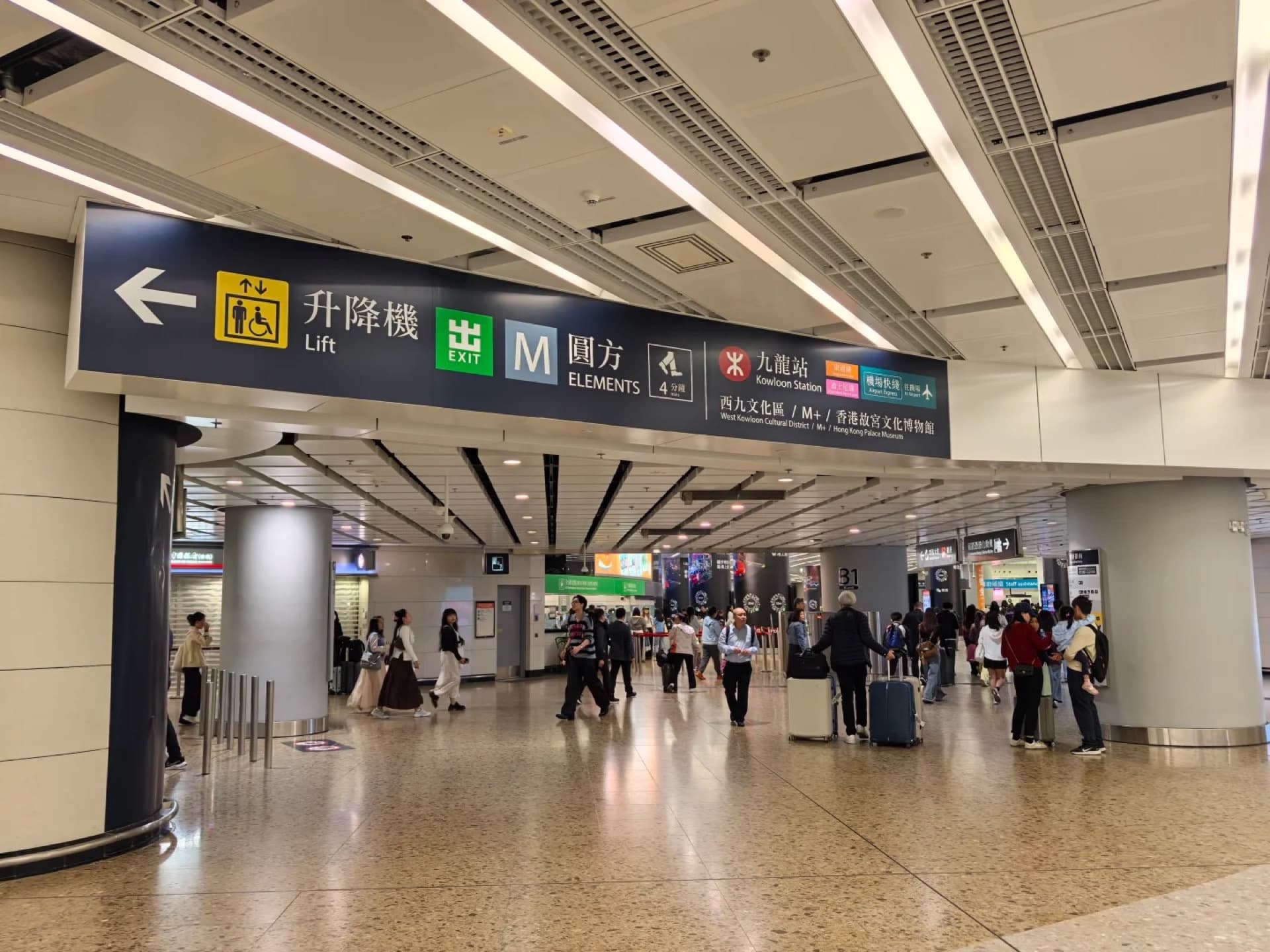 A guide helping tourists at the Hong Kong-Shenzhen border crossing